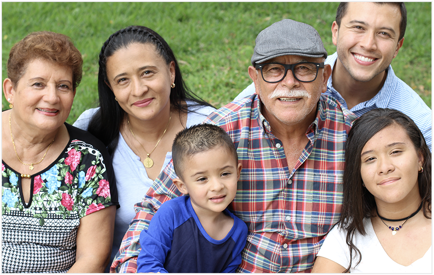 Multi-generational family in the park, smiling for the camera